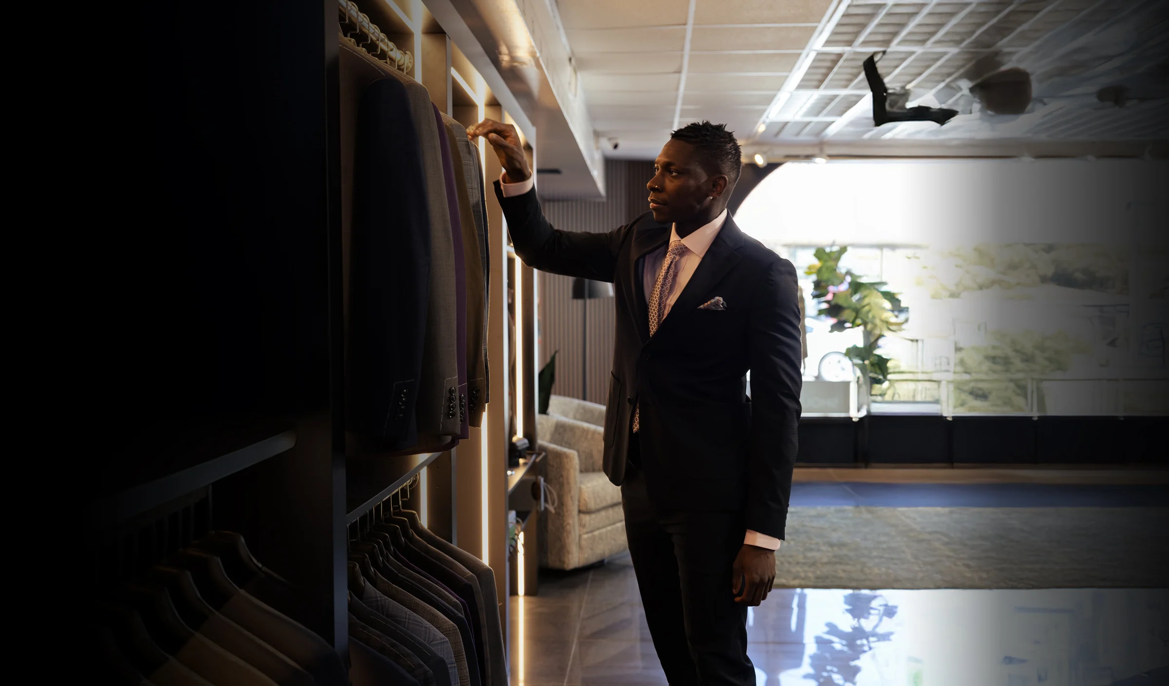 Client browsing tailored suits in a menswear showroom